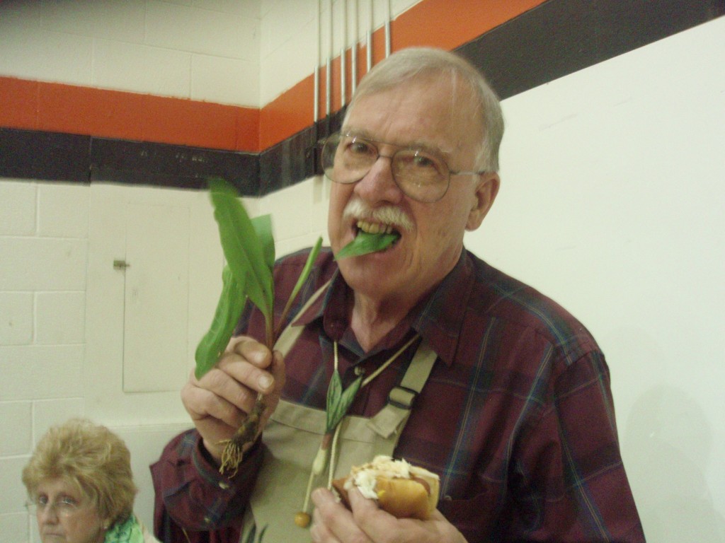 Glen Facemire, who owns the Ramp Farm in Richwood, eating fresh ramps and a ramp hotdog. 